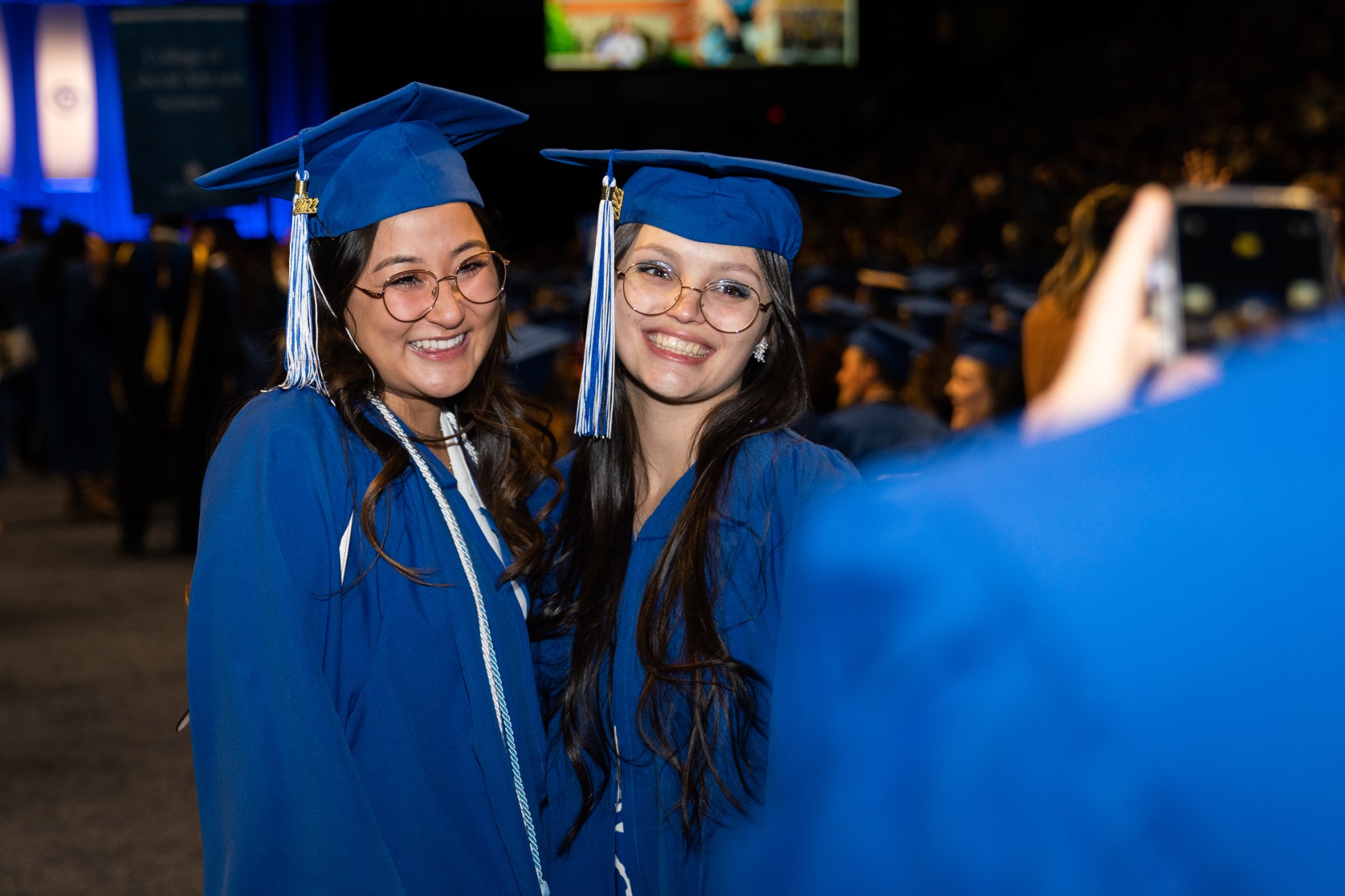two students smiling at commencement